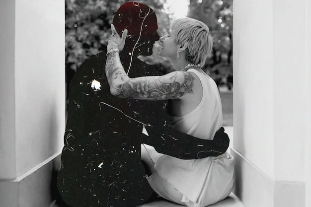 A black and white photo of a celebrity couple embracing tenderly, conveying a sense of deep emotional connection and genuine affection.