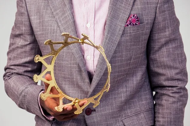 A close-up shot of a celebrity wearing a custom-designed suit with intricate embroidery and embellishments. The focus is on the details of the craftsmanship, capturing the texture of the fabric and the precision of the stitching.