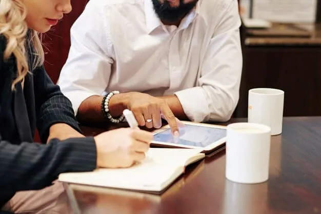 An image showing two sets of hands signing a legal document at a table with financial charts in the background, representing the financial agreement being made with expert advice.