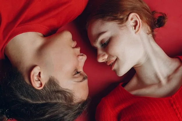 A close-up shot of a celebrity couple embracing on a red carpet, their faces radiating happiness and affection. The focus is on their genuine emotional connection.