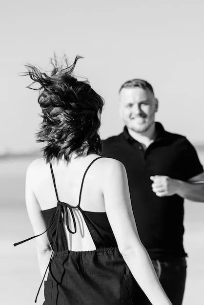 A black and white photo of a celebrity couple dancing intimately at their wedding reception. The background is softly blurred, creating a romantic and private atmosphere. The bride is in a vintage gown and the groom is in a classic tuxedo.