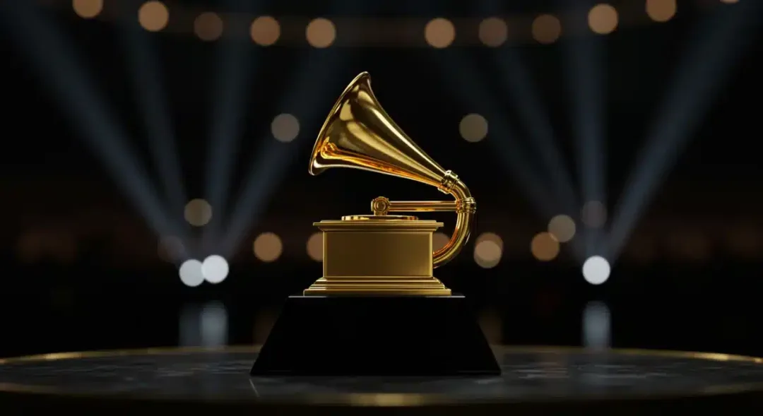 Golden Grammy trophy on a spotlighted stage, symbolizing music awards and anticipation for 2026.