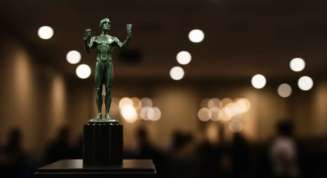 Golden SAG Awards statuette on a pedestal, representing excellence in ensemble acting recognition.
